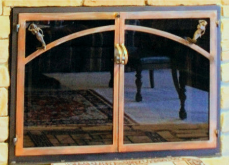 Mariner's Wife fireplace doors all black frame with mermaid motif. twin doors standard forged handles in ancient aged finish and smoked glass. Comes with slide mesh